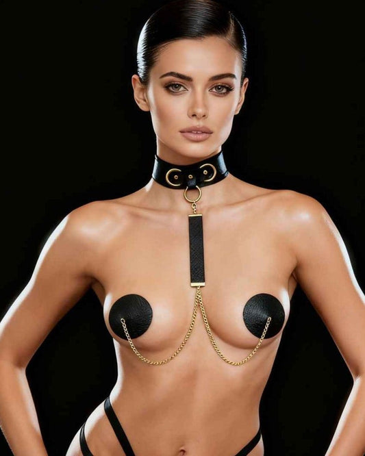 Angelina nipple covers with leather choker, gold chain and black pasties, on a model facing the camera, black background