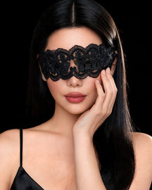Abigael black floral lace blindfold mask with scalloped edges, worn by a model, black background