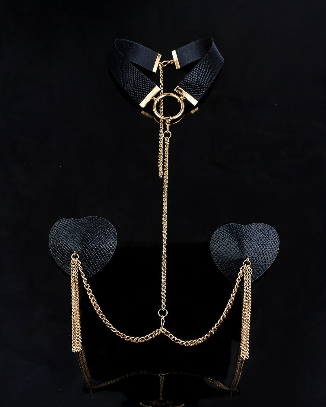 Madonna nipple covers set: black choker with gold ring, chain and black heart pasties with gold tassels, black background