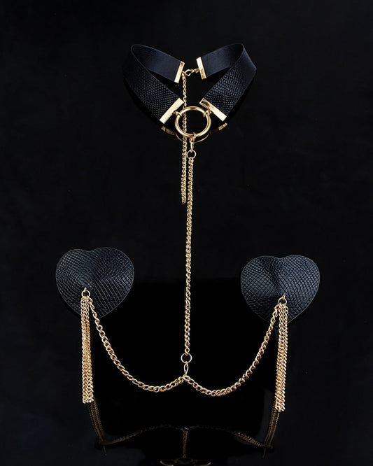 Madonna nipple covers set: black choker with gold ring, chain and black heart pasties with gold tassels, black background