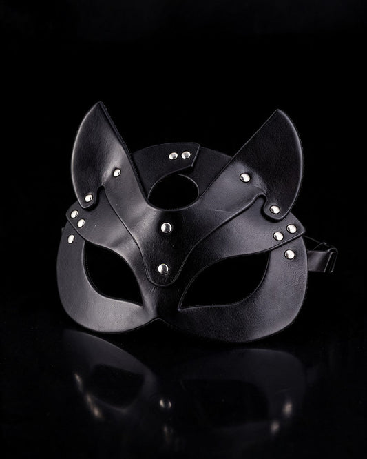 Black faux-leather cat mask with silver rivets, black background